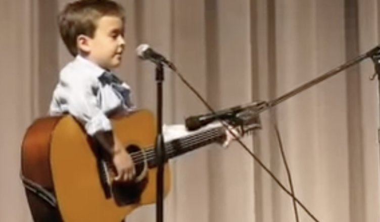 Your ears won’t believe what you hear! The audience is amazed by a first-grader’s remarkably sophisticated rendition of a Johnny Cash song.