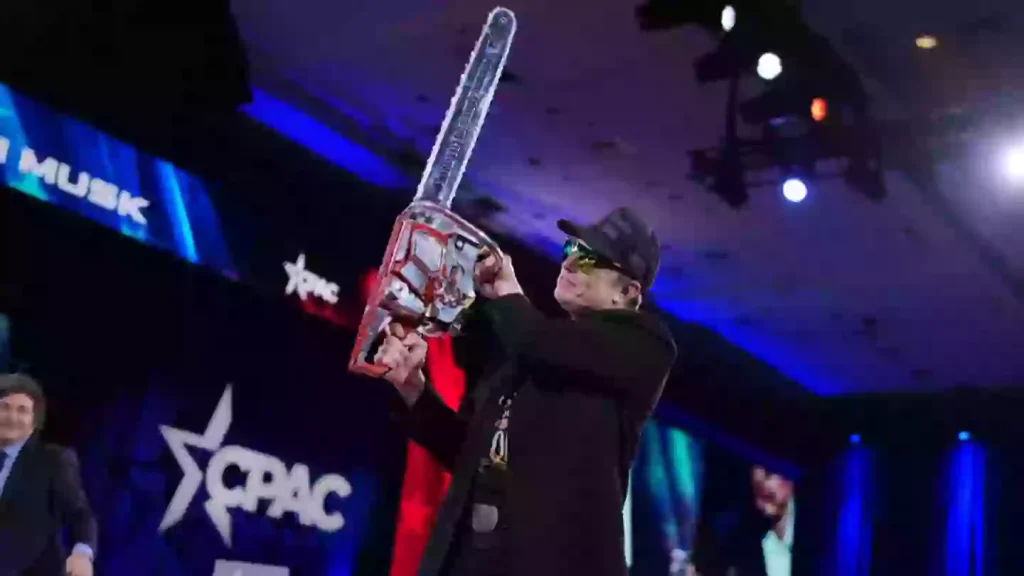 Elon Musk waves ‘chainsaw for bureaucracy’ on stage in bizarre CPAC appearance